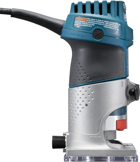 Side profile view of the router displaying the ergonomic rubberized grip area, the angled cord exit, and the spindle lock button.