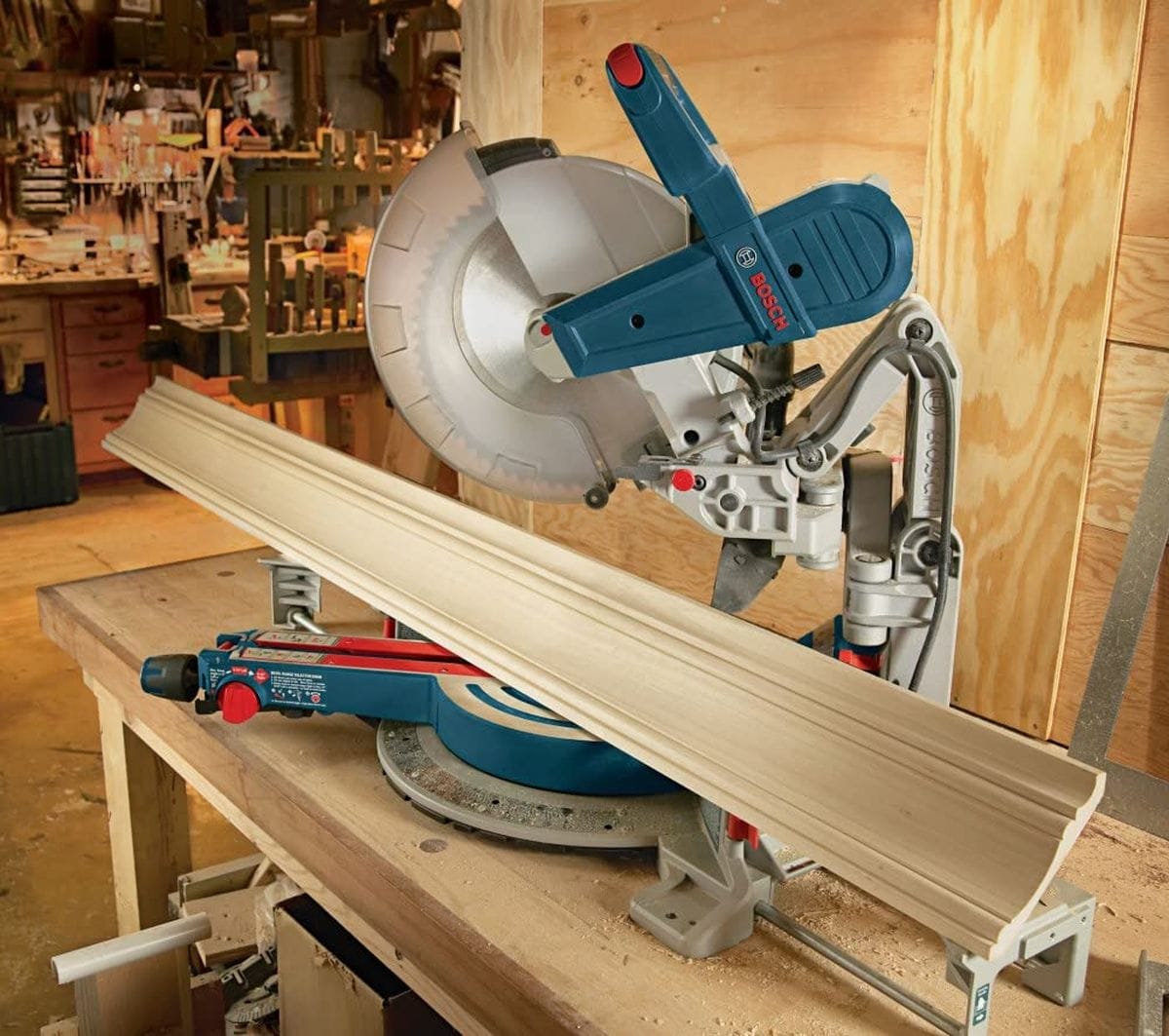 A close-up application shot of the Bosch PRO1280FIN blade in a miter saw setup, perfectly aligned to cut decorative crown molding with a smooth, professional finish that requires minimal sanding.