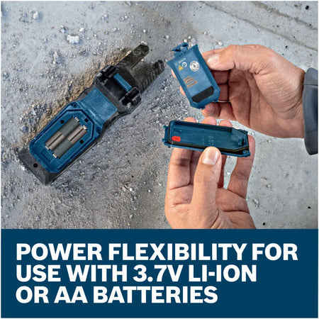 An overhead view of a technician removing the rear battery compartment cover plates from the back of the Bosch PRO GFM1000-15 multi tester. The text banner below reads Power flexibility for use with 3.7V Li-Ion or AA batteries, highlighting dual fuel choices and automatic safety power cut off engineering.