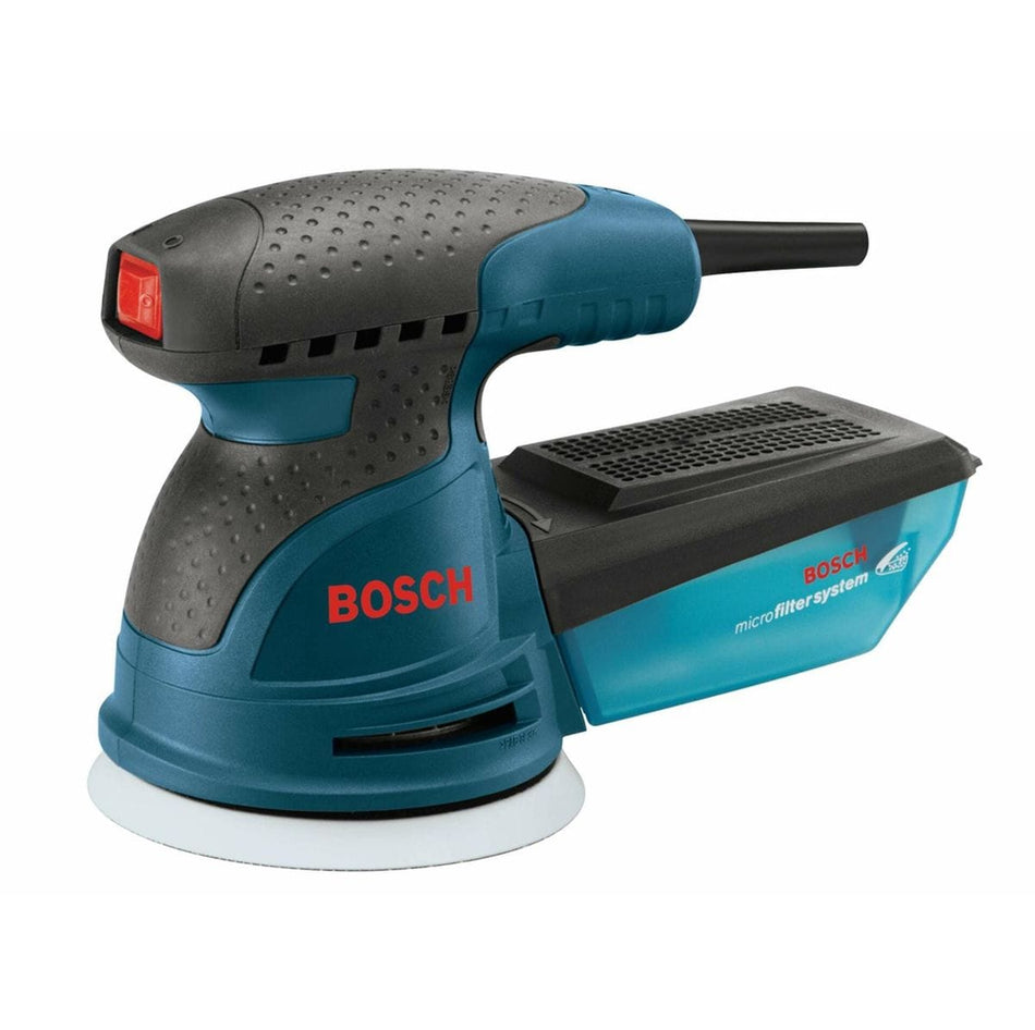 Bosch ROS10 random orbit sander with textured grip, red power button, and visible microfilter dust canister. The sanding pad is shown at the bottom, emphasizing the tool’s swirl-free finish and dust collection capability