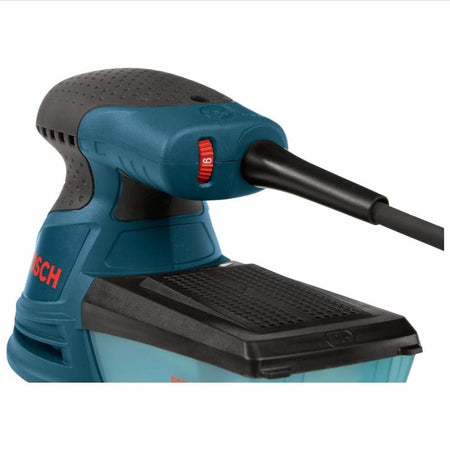 A close-up back-angle view of the sander's rear handle handle area, highlighting the red variable-speed thumbwheel dial resting directly beneath the reinforced power cord protection boot.