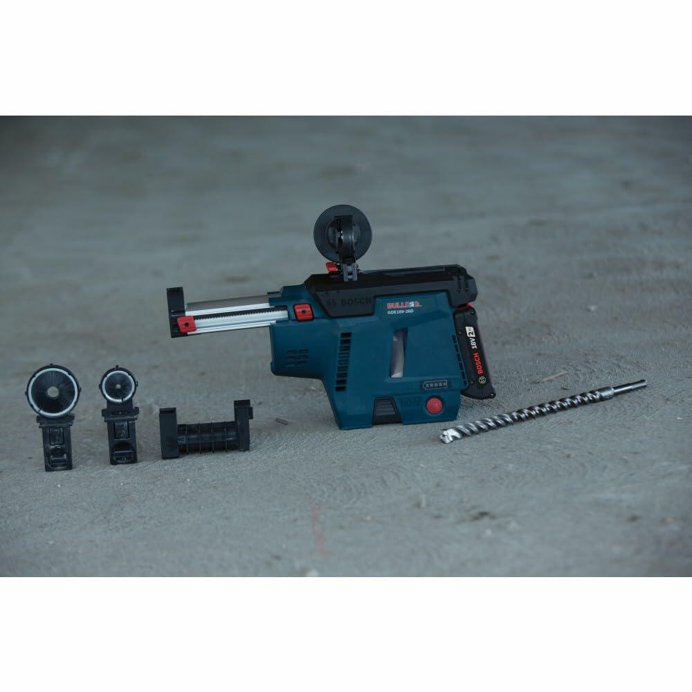 Bosch GDE18V-16 dust extractor with accessories including nozzle adapters, mounting bracket, and spiral drill bit on concrete surface.