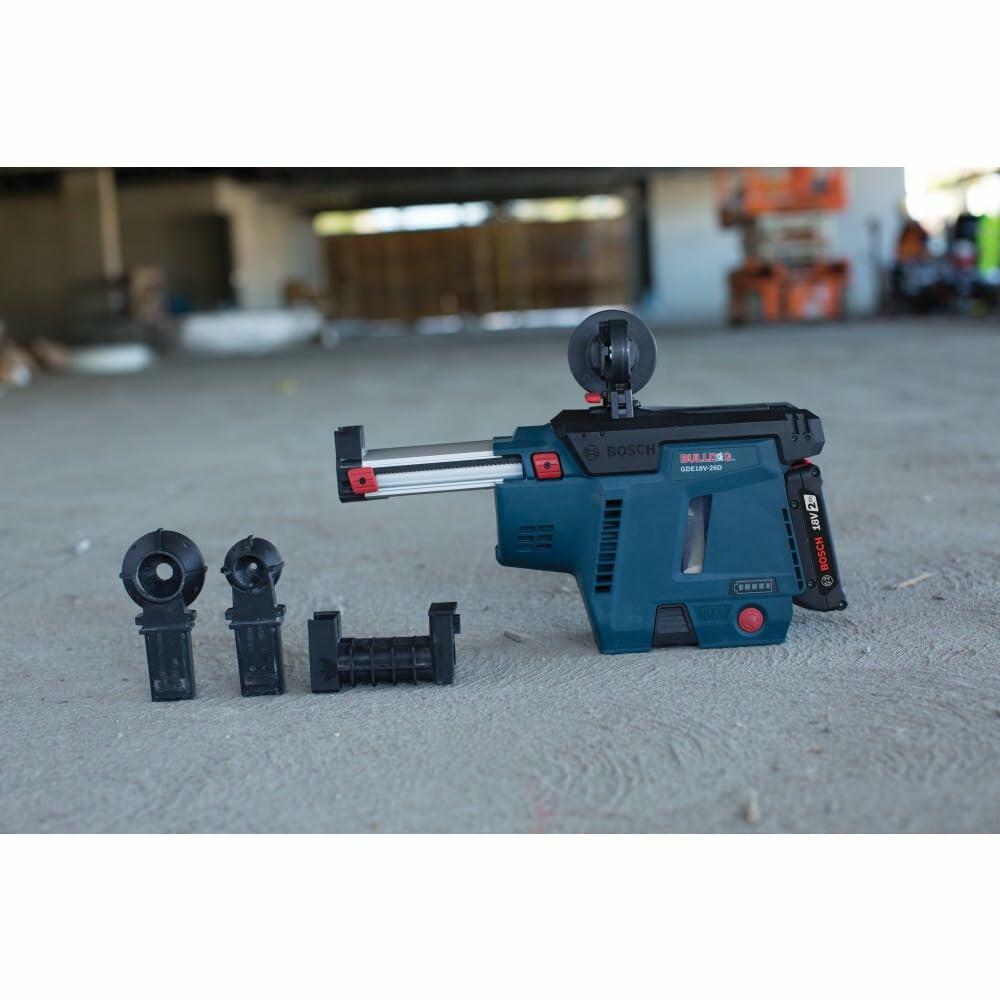 Bosch rotary hammer and GDE18V-16 dust extractor setup on concrete surface; includes drill bit and multiple nozzle attachments.