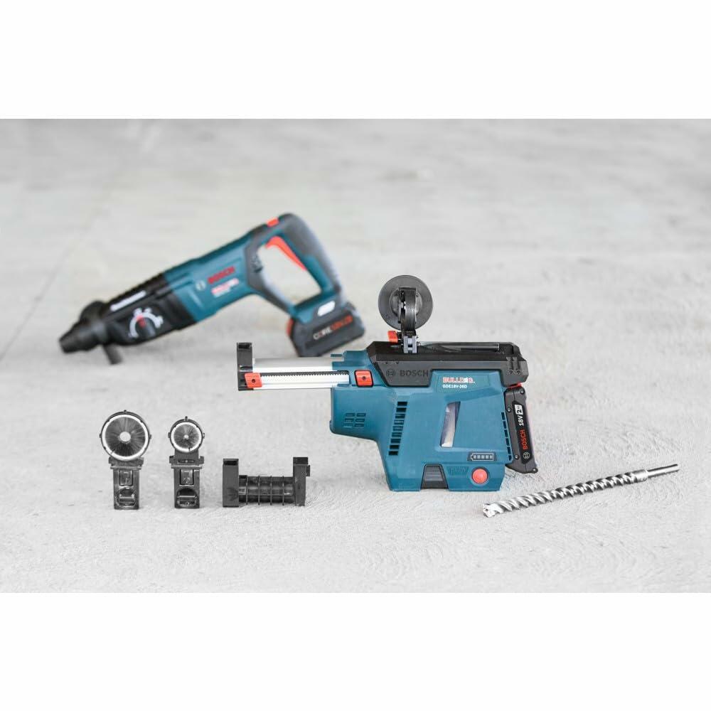 Bosch GBH18V-26DK rotary hammer with dust extraction system and accessories laid out on concrete in construction environment.
