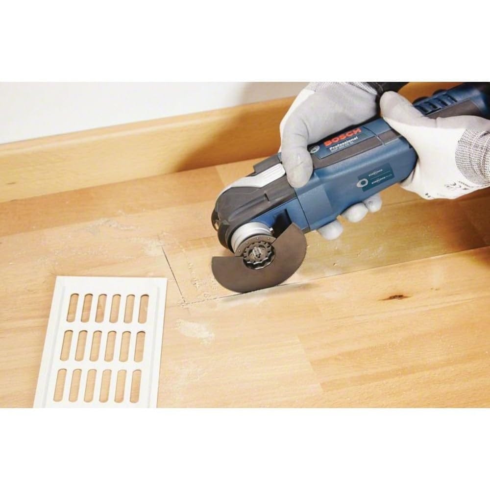 Action shot of the blade cutting a rectangular opening in laminate flooring for a vent installation.