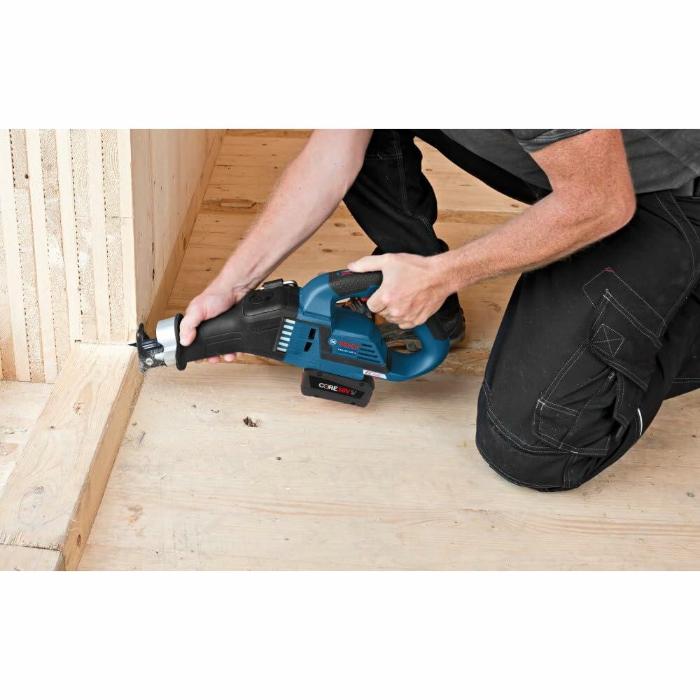 User kneeling on a wooden floor operates a Bosch cordless reciprocating saw to cut a vertical beam. The image highlights ergonomic use and the saw’s capability for precise cuts in carpentry or framing work.