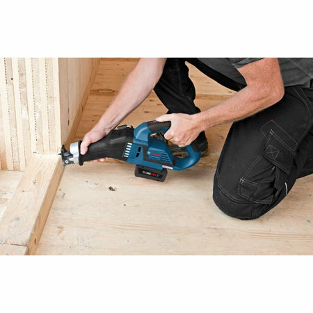 User kneeling on a wooden floor operates a Bosch cordless reciprocating saw to cut a vertical beam. The image highlights ergonomic use and the saw’s capability for precise cuts in carpentry or framing work.