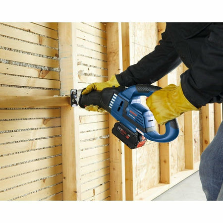 Person wearing yellow gloves uses a Bosch reciprocating saw to cut horizontal wooden lath strips on a wall. The image illustrates the tool’s effectiveness in remodeling or removing traditional plaster wall structures.