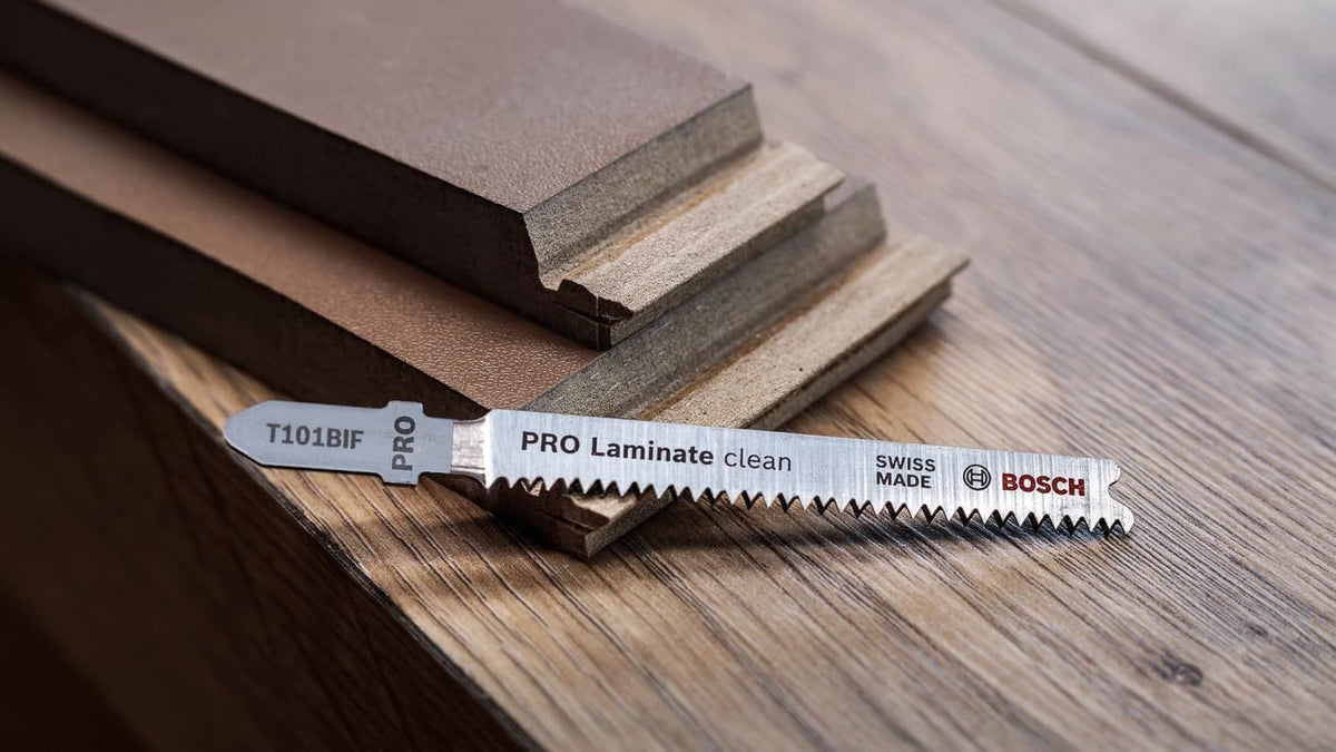 The Bosch T101BIF jig saw blade displayed alongside professional laminate flooring samples, showcasing its specific application for high-quality residential and commercial flooring projects.