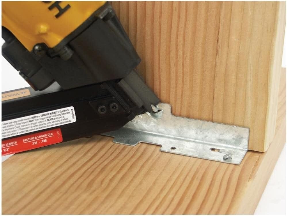 Close-up perspective of the Bostitch MCN150 STRAPSHOT magazine and nosepiece, showcasing the exposed nail tip design that guides the 1-1/2 inch fastener precisely into pre-drilled connector holes.