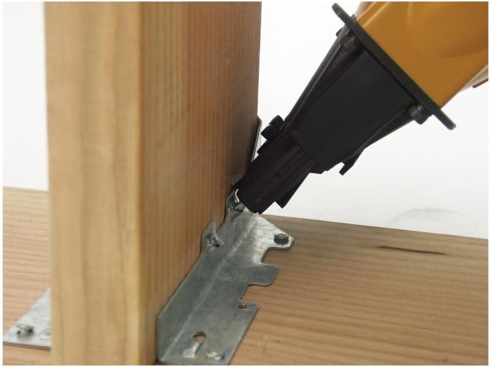 The Bostitch MCN150 STRAPSHOT pneumatic nailer resting securely within its custom-fitted heavy-duty gray carrying case for organized storage and protection on construction sites.