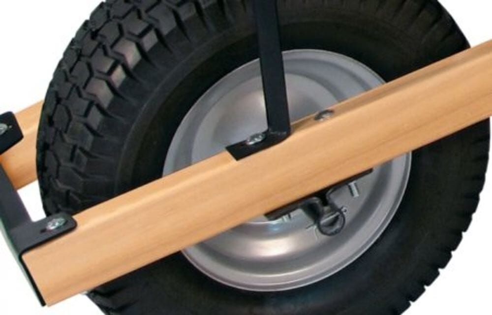 Heavy-duty wheel assembly on the Brentwood wheelbarrow showing the wide pneumatic turf tire, steel rim, and 3/4-inch axle mounting.