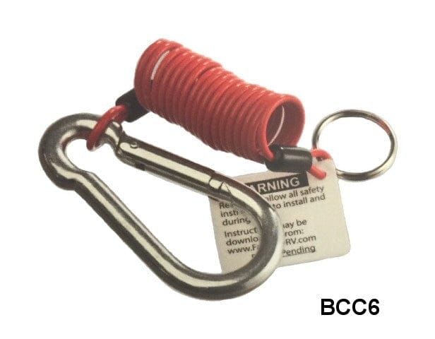 Brophy BCC6 breakaway safety cable assembly shown coiled in red with a metal carabiner clip, key ring, and attached warning tag. The coiled design prevents tangling and allows flexible movement, while the carabiner secures the cable to a fixed point. The tag includes safety instructions and a website link. Used to activate trailer brakes in case of hitch separation.