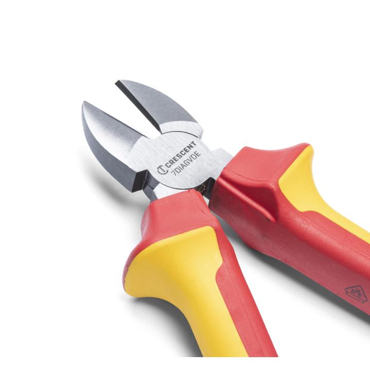 This is a close-up photograph of Crescent 7" VDE Insulated Diagonal Cutting Pliers, angled to show the cutting blades and part of the insulated handles.

The image focuses on the silver cutting blades, which are open, and the red and yellow insulated handles. The "Crescent" logo and model number are visible on the pliers' head. The shot is taken from a low angle, emphasizing the tool's design and features. The background is blurred, highlighting the details of the pliers.