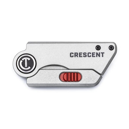 This is a picture of a small, folded utility knife. It has a silver body with a textured grip and a red slider button. You can feel the brand name "Crescent" raised on the body of the knife.