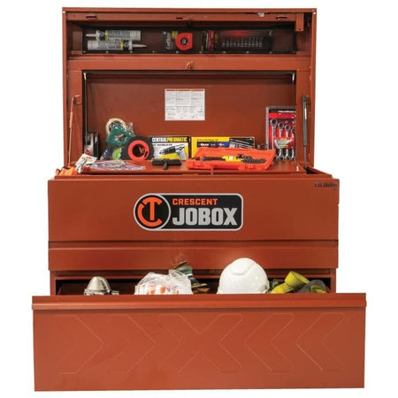 Crescent JOBOX chest with open lid and drawer, filled with tools and safety equipment including pipe wrench, screwdriver set, hard hat, and harness.