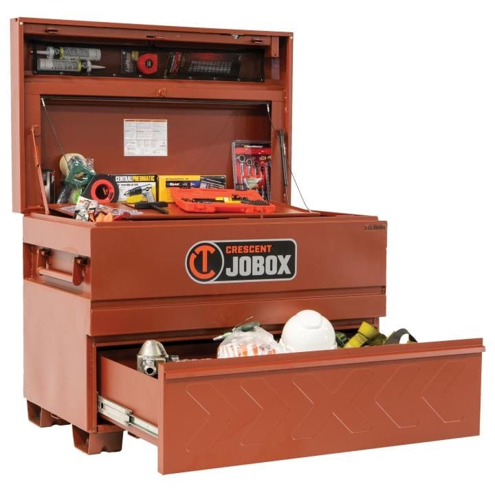 Crescent JOBOX chest with open lid and drawer, displaying organized tools and safety gear including a level, tape measure, hard hat, and flashlight