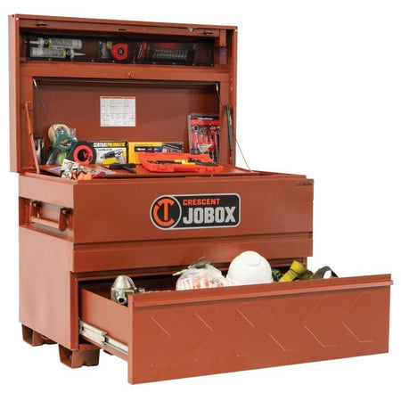 Crescent JOBOX chest with open lid and drawer, displaying organized tools and safety gear including a level, tape measure, hard hat, and flashlight