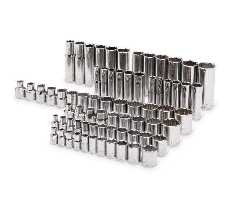 A white background studio shot showcasing a large organized collection of chrome sockets from the 121-piece set, arranged in rows by size and depth, highlighting both standard and deep well options.