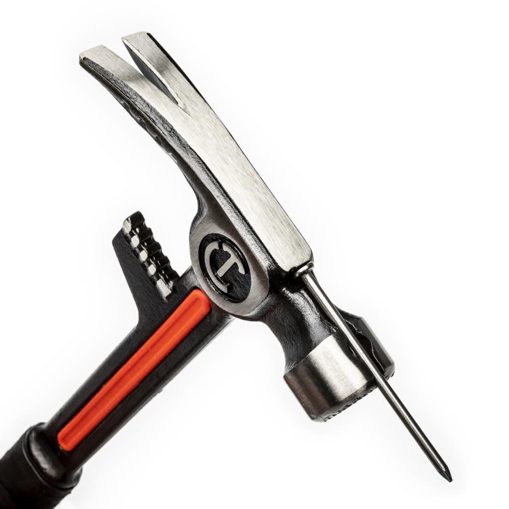 A close-up view of the Crescent demo hammer head demonstrating the magnetic nail starter feature holding a steel nail in place for easy one-handed starting.