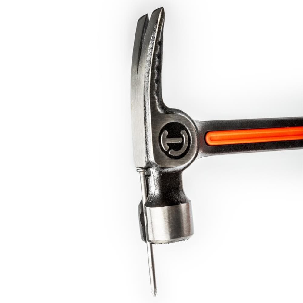 Close-up view of the Crescent 28oz framing hammer head demonstrating the magnetic nail starter feature, securely holding a large framing nail in place for easy one-handed starting.