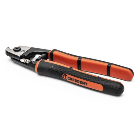 A side profile of the Crescent wire rope and cable cutter resting on a white surface, showcasing the slim tool design and the integrated locking latch for safe storage.
