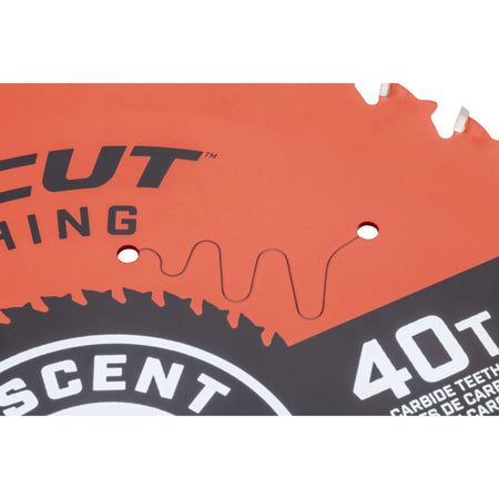 Close-up detail of the laser-cut expansion slots on the Crescent FineCut 40-tooth circular saw blade, engineered to reduce warping and burning on fine woodworking finishes.