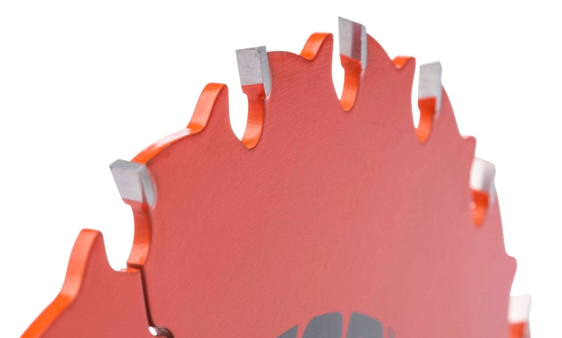 Close-up of red circular saw blade with sharp silver carbide teeth designed for cutting wood materials.