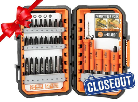 Open Crescent APEX 30-piece fastening bit set displayed in a black and orange alphaCASE storage box. The left side shows rows of labeled bits including Phillips, Torx, and slotted types, with a label reading "2X MORE DURABLE - 50% BETTER GRIP." The right side features orange u-GUARD non-marring sleeves over magnetic nutsetters and bits, with a promotional card highlighting protection benefits. A red ribbon in the corner suggests the set is gift-ready.