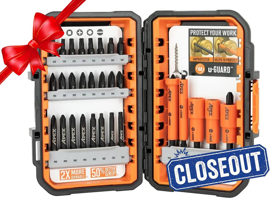 Open Crescent APEX 30-piece fastening bit set displayed in a black and orange alphaCASE storage box. The left side shows rows of labeled bits including Phillips, Torx, and slotted types, with a label reading "2X MORE DURABLE - 50% BETTER GRIP." The right side features orange u-GUARD non-marring sleeves over magnetic nutsetters and bits, with a promotional card highlighting protection benefits. A red ribbon in the corner suggests the set is gift-ready.