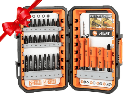 Open Crescent APEX 30-piece fastening bit set displayed in a black and orange alphaCASE storage box. The left side shows rows of labeled bits including Phillips, Torx, and slotted types, with a label reading "2X MORE DURABLE - 50% BETTER GRIP." The right side features orange u-GUARD non-marring sleeves over magnetic nutsetters and bits, with a promotional card highlighting protection benefits. A red ribbon in the corner suggests the set is gift-ready.