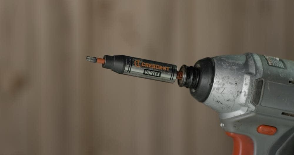 Close-up side view of a Crescent APEX Vortex bit holder inserted into an impact driver chuck with a Torx bit loaded.
