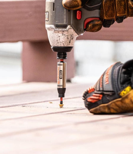 Close-up of a worker using a power tool to drive a screw using a Crescent APEX Vortex bit holder.