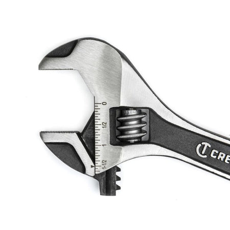 An extreme macro studio photograph focusing entirely on the open head configuration of the Crescent hand tool, detailing the micro-serrated teeth patterns inside the jaws and the high-contrast laser-etched dimension increments.