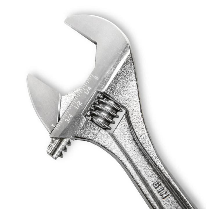 Macro close-up shot focusing on the head of the 6-inch compact hand tool from the Crescent AC2610VS wrench set. The permanent laser-etched SAE and metric scale markings are highly visible along the jaw jaw profile next to the precision adjustment knurl.
