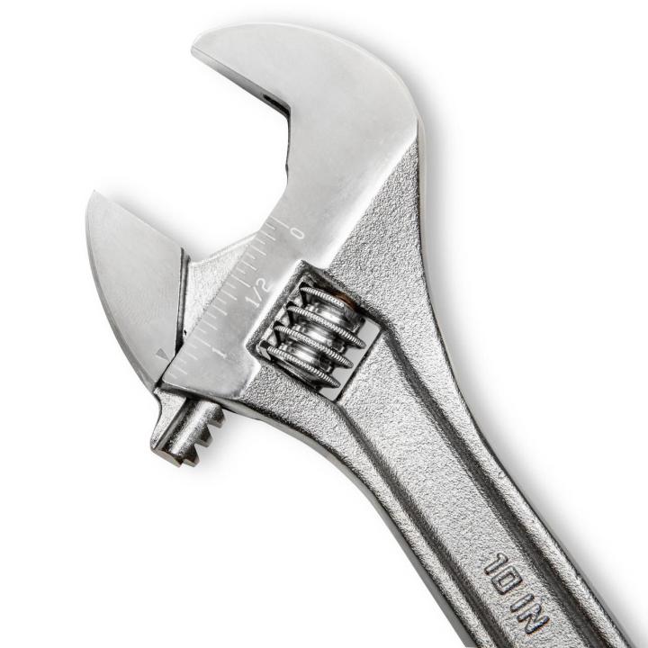 Detailed macro image of the 10-inch heavy-duty adjustable wrench head from the Crescent AC2610VS set. This view highlights the wide 1-5/16 inch jaw opening capacity, fractions scale tracking system, and premium heat-treated forged steel alloy texture.