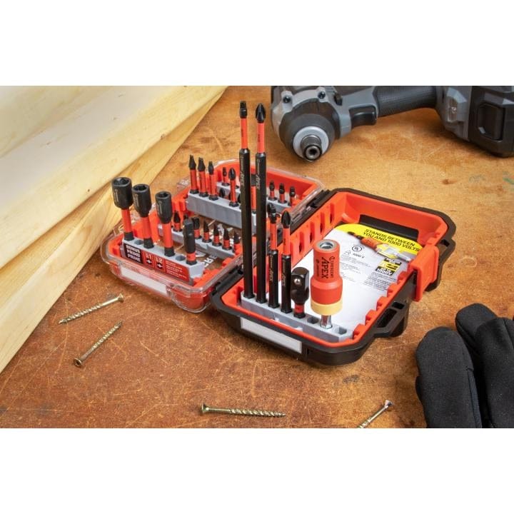 A close-up of the Crescent Apex insulated bit set in use on a jobsite, showcasing the eSHOK-GUARD isolation zone technology designed to protect tradesmen from electric shock up to 1,000 volts.