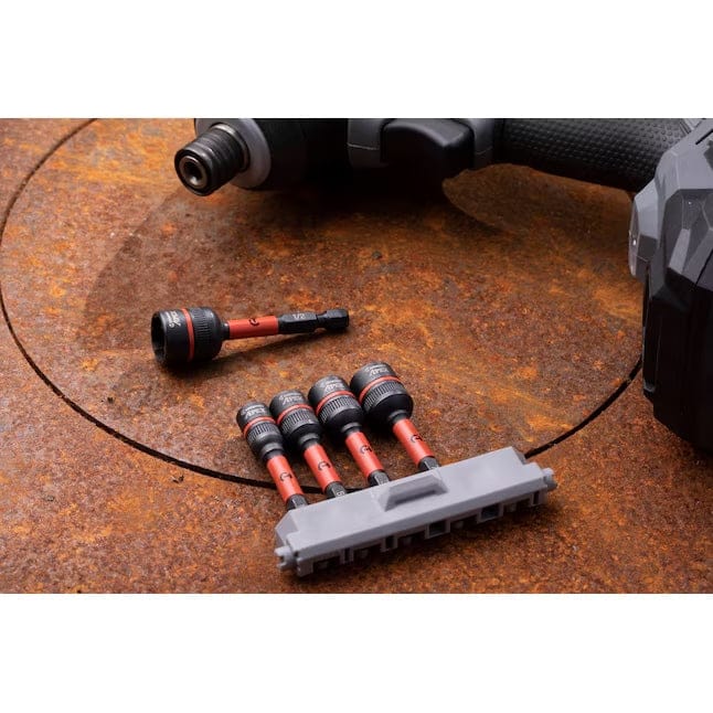 The Crescent Bolt Biter extractor set resting on a rusted metal surface next to an impact driver, demonstrating the tool's specialized use for heavy-duty automotive and industrial repairs.