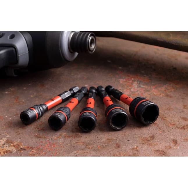 Five Crescent impact bolt extractors laid out on a weathered metallic surface to showcase the various SAE sizes and the robust Chrome Molybdenum alloy steel construction.