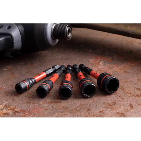 Five Crescent impact bolt extractors laid out on a weathered metallic surface to showcase the various SAE sizes and the robust Chrome Molybdenum alloy steel construction.