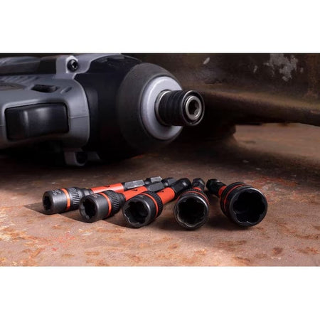 A low-angle shot of the Crescent Bolt Biter extractors positioned in front of a professional impact driver, emphasizing the 1/4 inch hex shank and impact-rated durability.