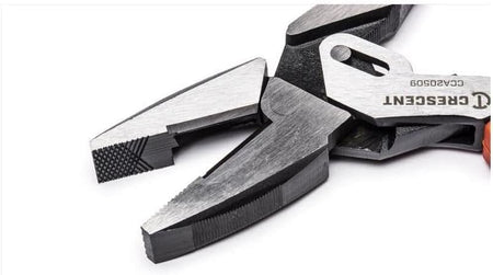A close-up view of the serrated jaws on the Crescent compound action pliers, highlighting the machined cross-check knurling pattern designed for a non-slip grip and the high-leverage pivot joint.