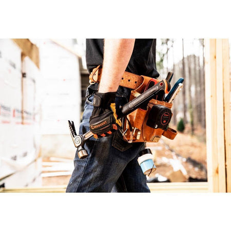 A professional contractor carrying the Crescent CHSFRM22 all-steel framing hammer in a leather tool belt on a construction job site.