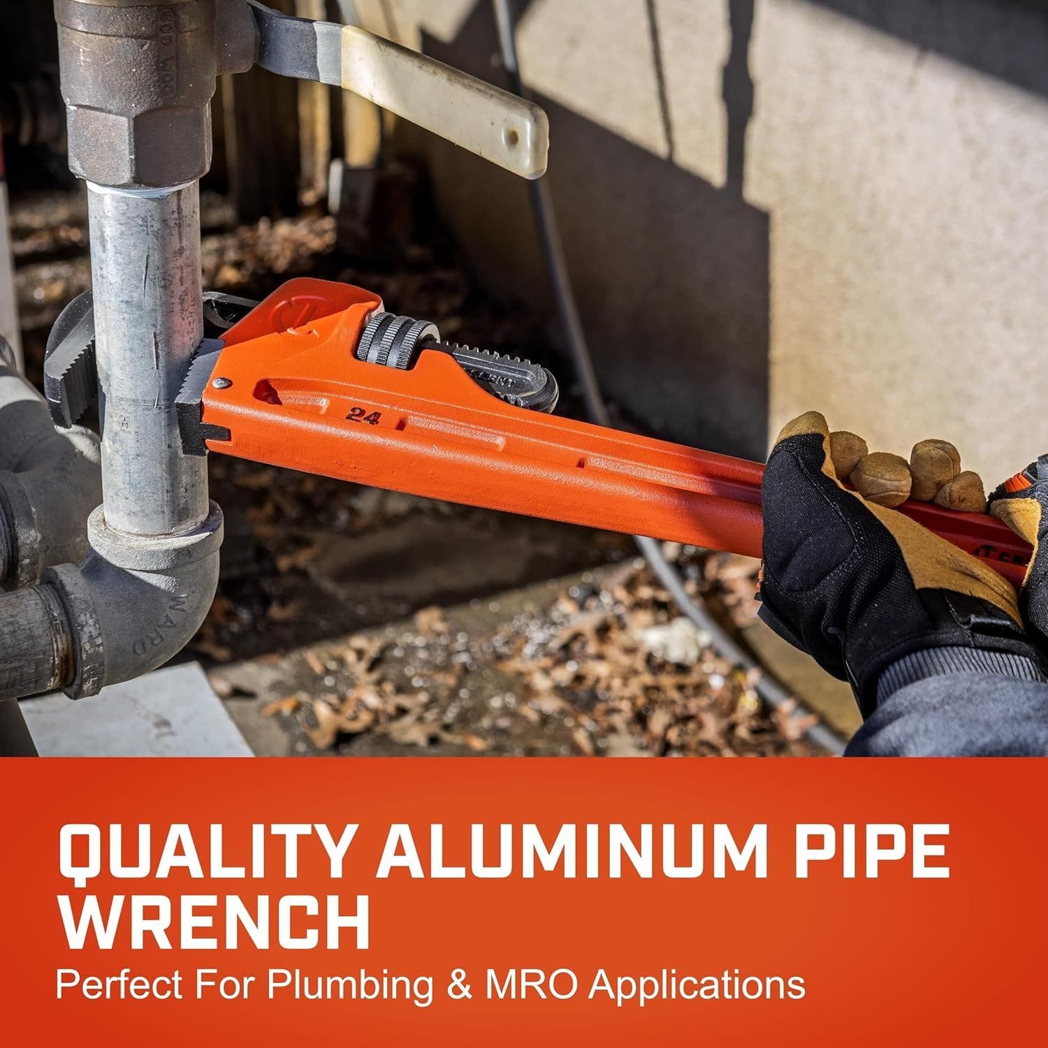 An outdoor e-commerce lifestyle photograph of a technician wearing safety work gloves using the red 24-inch pipe wrench to turn a galvanized metal pipe fitting, accented by a solid red lower banner with white text that reads Quality Aluminum Pipe Wrench Perfect For Plumbing & MRO Applications.