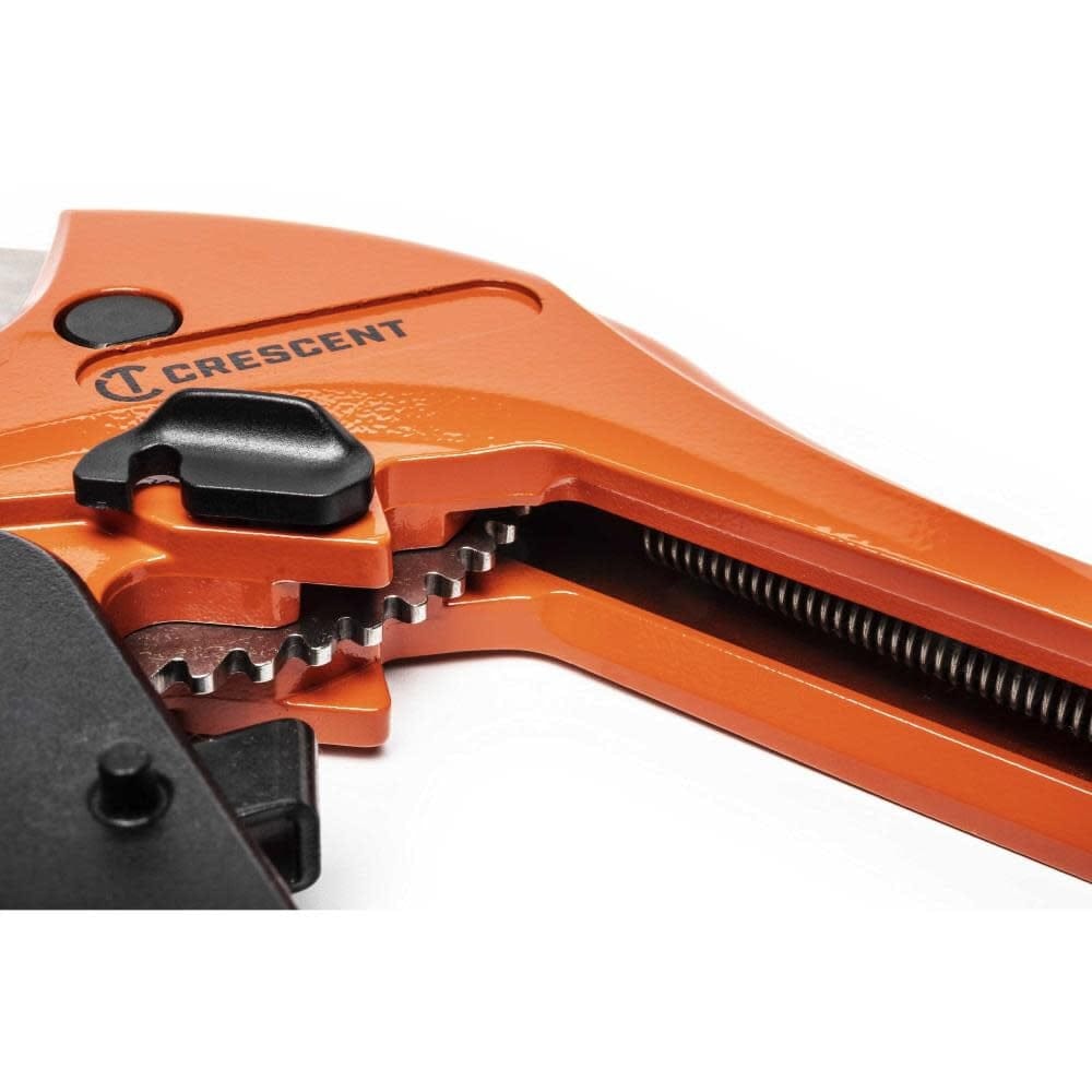 A perspective view focusing on the internal ratcheting teeth and return spring of the Crescent 1-1/8 inch PVC cutter, highlighting the heavy-duty construction designed for high-volume professional use.