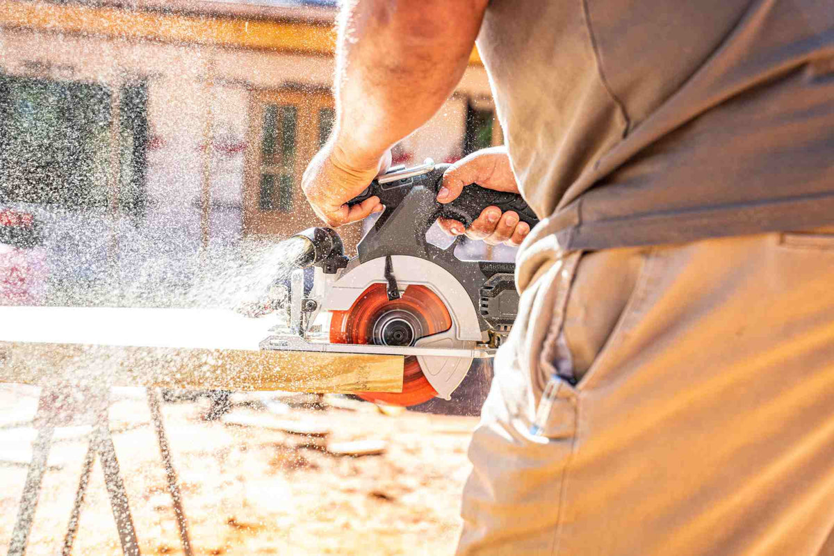 Jobsite application photo of a professional carpenter using a Crescent NailSlicer circular saw blade to crosscut heavy timber, emphasizing the blade's durability in rugged framing environments.