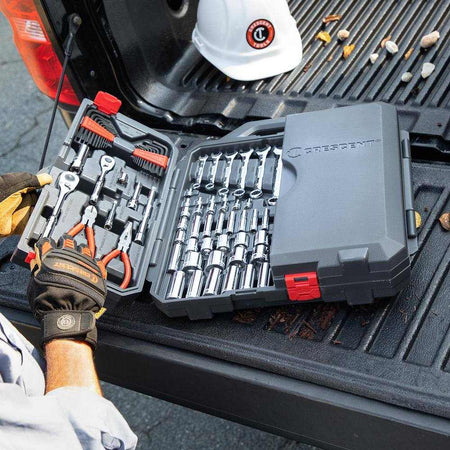A lifestyle shot of the Crescent CTK180 tool set in its carrying case resting on the tailgate of a truck, demonstrating its portability and organization for mobile mechanics.