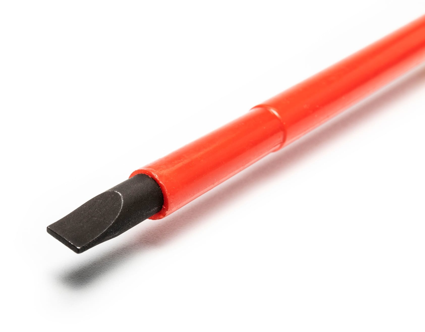 Close up of a slotted screwdriver from the Crescent electrical hand tools set featuring a durable heat treated black oxide tip.