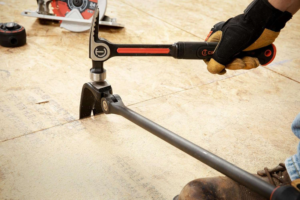 Action shot of a hammer hitting the raised striking surface of the Crescent 30-inch indexing pry bar to drive the precision ground edge deep into a tight gap between flooring materials.