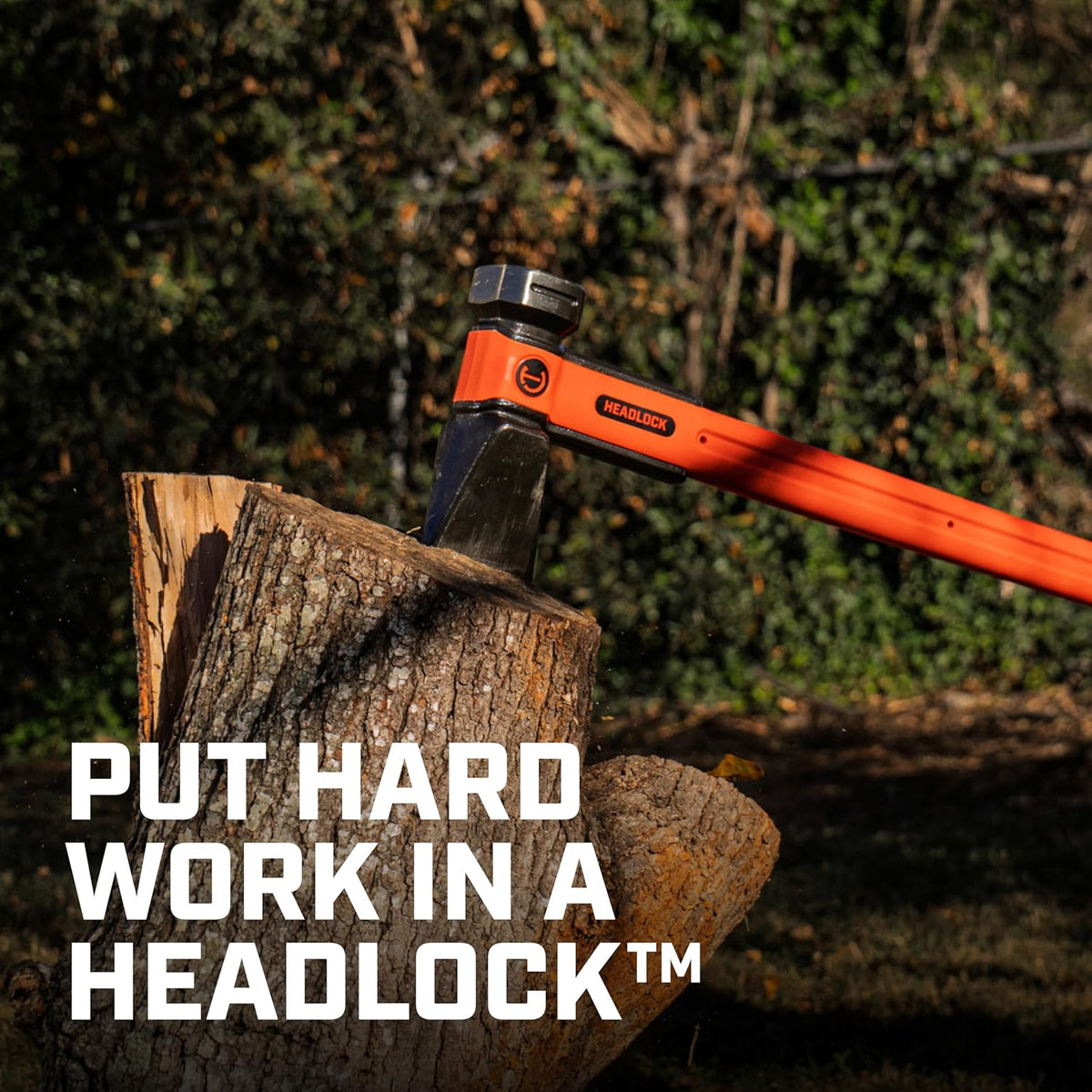 A high-impact action shot of the Crescent HEADLOCK splitting maul embedded in a large wooden log, demonstrating the tool's massive splitting power with the marketing slogan Put Hard Work in a HEADLOCK.